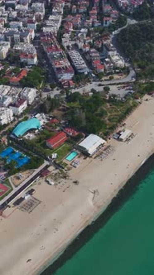 Vertical Video of a Magical Seaside Beach on the Mediterranean Shore With Gentle Waves and Lush