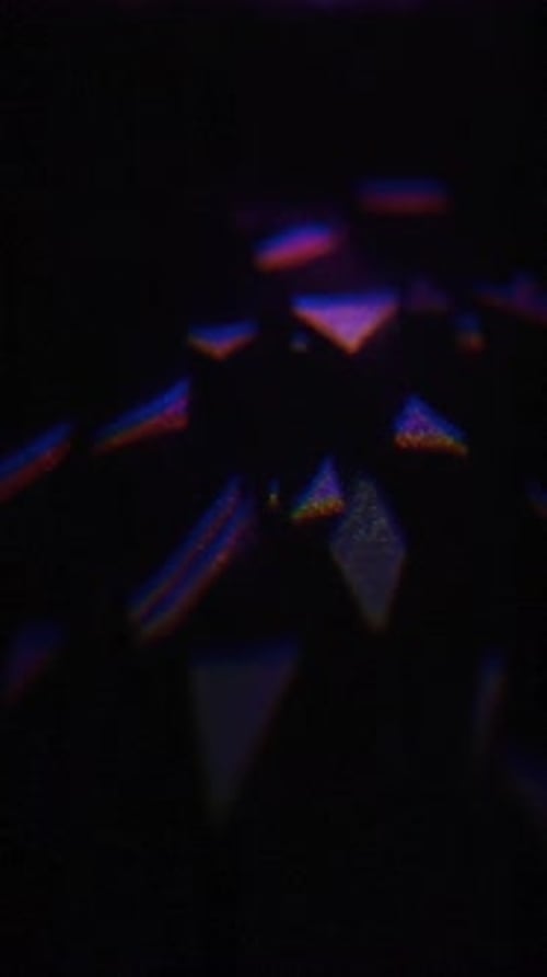Abstract prism shimmering light leak on black backdrop