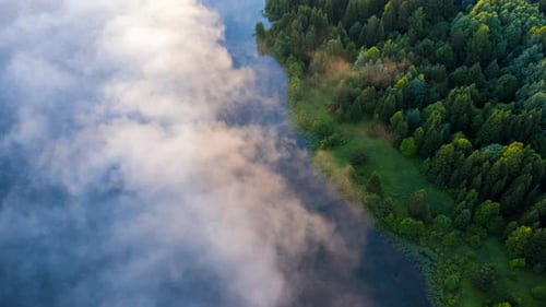 Fog on lake timelapse. Aerial timelapse of the lake with morning fog forming over the water surface