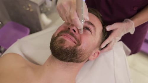 Man Receiving Facial Treatment in Aesthetic Clinic