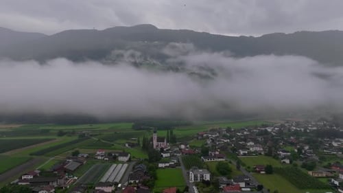 Aerial Cinematic Left to Right Over Misty Dolomites Austria with Church Visible