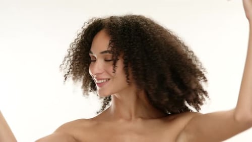Woman Posing with Curly Hair in Studio