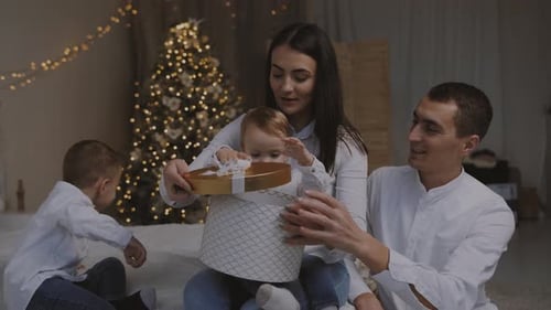 Young family unpack the Christmas present