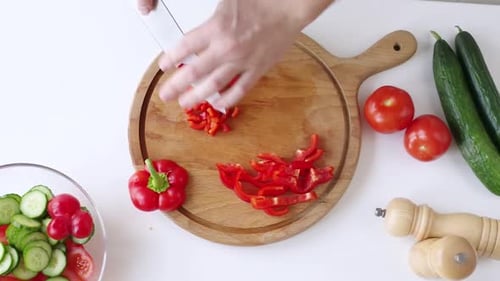 Preparing Fresh Salad with Red Pepper and Vegetables