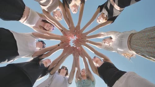 Group of Students Joining Hands in Circle Forming a Union