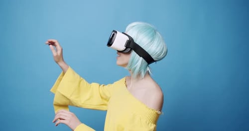 Woman Using Virtual Reality Headset on Blue Background