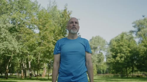 Adult Man Exercising with Dumbbells in Park