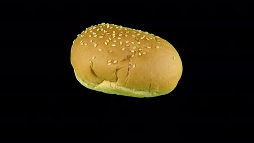 Burger Bun Rotating Against Black Background
