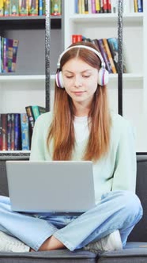 Vertical Screen Cheerful Female Working on Notebook in Library