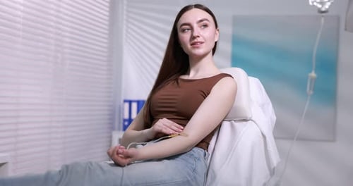 Young woman with IV drip in hospital