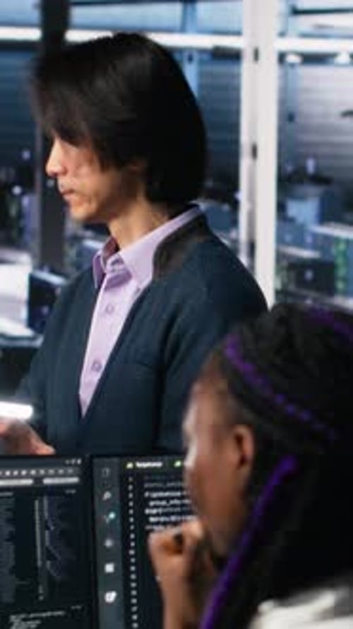 Vertical Video Software Developers Cooperating in Data Center Reviewing AI Diagnostics