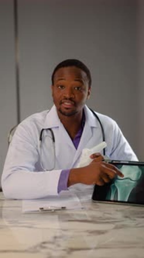 Doctor Explaining Knee Joint with Model and X-Ray