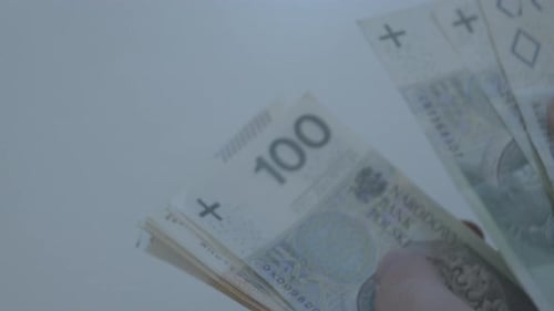 Men's hands are counting polish zloty banknotes of 50 100 200 bills. PLN