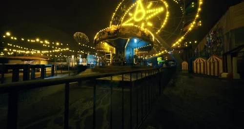 Dark Night Amusement Park with Twinkling Carnival Lights