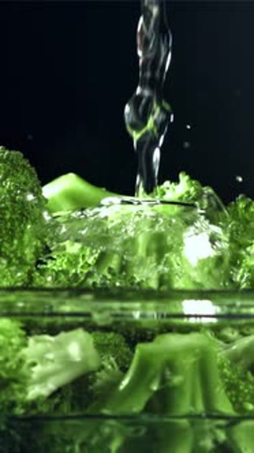 A Stream of Water Pours Into a Plate of Broccoli Filmed on a Highspeed Camera at 1000 Fps