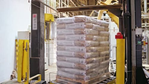 Shipping boxes wrapped in plastic shrink. Goods on a wooden pallet.