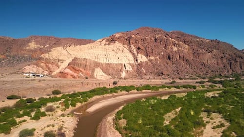 Aerial view drone flying over scenic red rocky mountains and a red river landscape