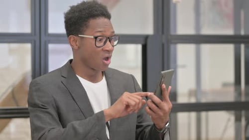 Excited Man Celebrating News on Mobile Phone
