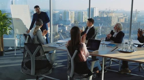 MultiRacial Office Staff Listening to Sales Seminar By Handsome Lecturer Negotiating and Solving