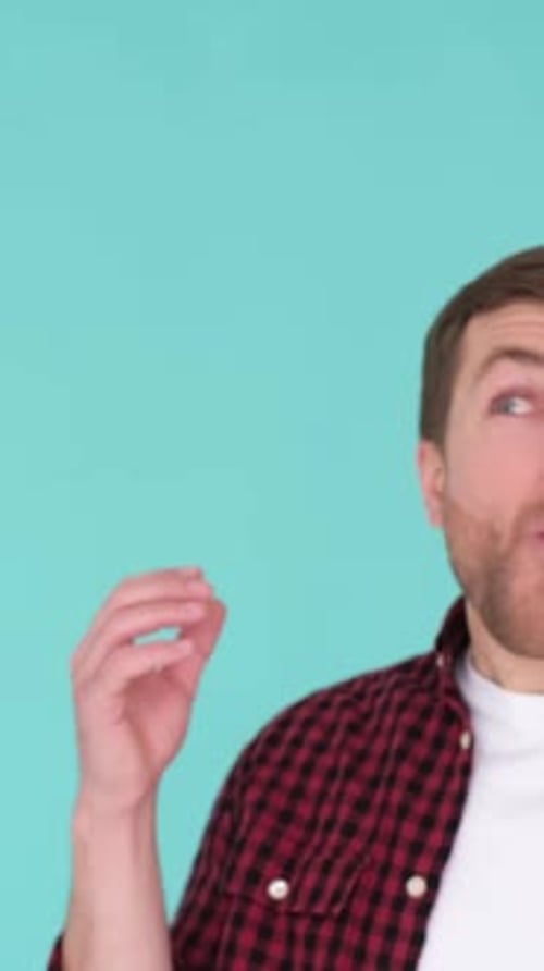 Man Reacts with Joyful Amazement, Light Blue Background
