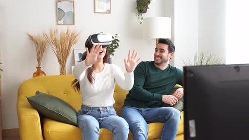 Woman Experiences Virtual Reality with Partner Watching