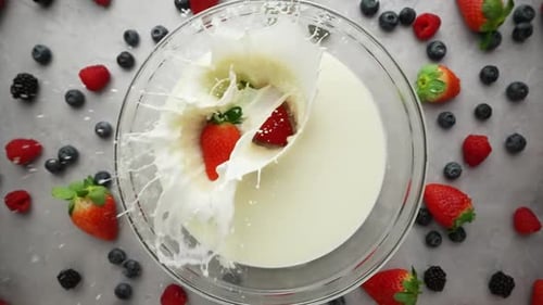 Strawberries Fall Into Milk in Slow Motion