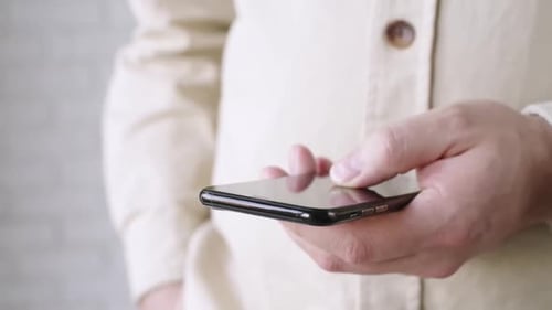 Hand Using a Mobile Phone Close Up