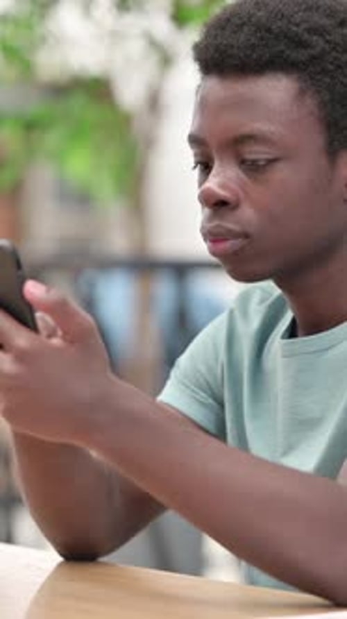 Teenager Using Smartphone with Happy Reaction