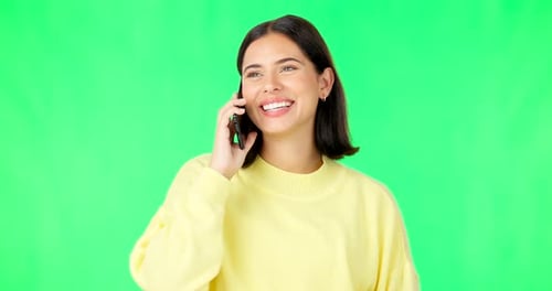 Happy woman, phone call and conversation on green screen for communication against a studio