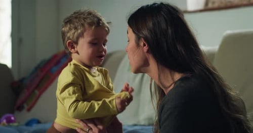 Portrait of a Woman Trying to Manage her Toddler Son While He is Throwing a Tantrum at Home. Male