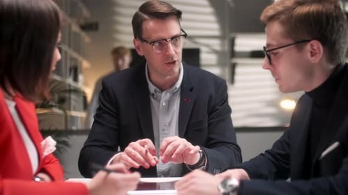 In Creative Office Productive Coworkers Standing at the Table Company Meeting Business People