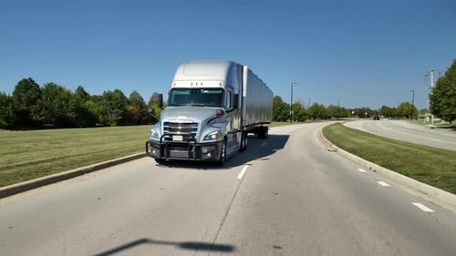 POV Front View of Delivery Truck Driving Close on a Scenic State Highway Logistics and
