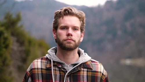 a serious looking man, who after a conversation had a little smirk on his face. He is walking down a