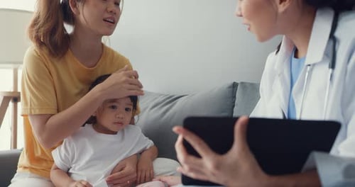 Doctor Showing Medical Information to Child at Home