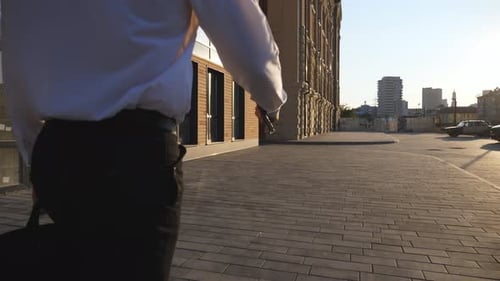 Rear View of Successful Businessman with Briefcase Walking at Urban Street Young Entrepreneur in