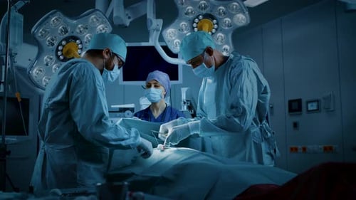 In the Hospital Operating Room Diverse Team of Professional Surgeons and Nurses Suture Wound after