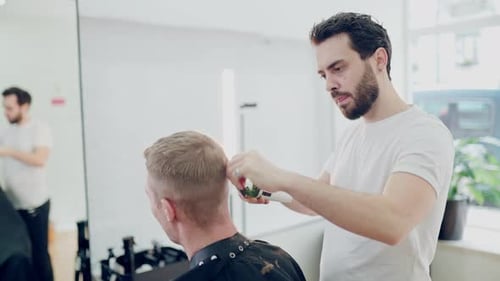 Man Getting Haircut by Barber in Bright Salon