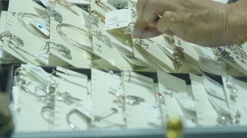 A Woman Chooses Earrings in a Jewelry Store