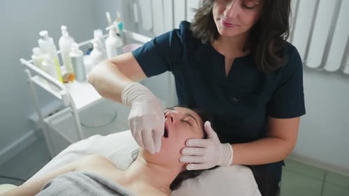 Woman Receives Buccal Massage in Bright Room
