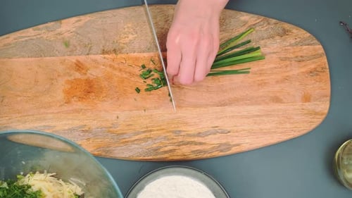 Cutting Green Onions with a Sharp Knife on a Cutting Board