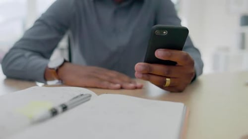 Man uses Phone at Desk in Modern Office