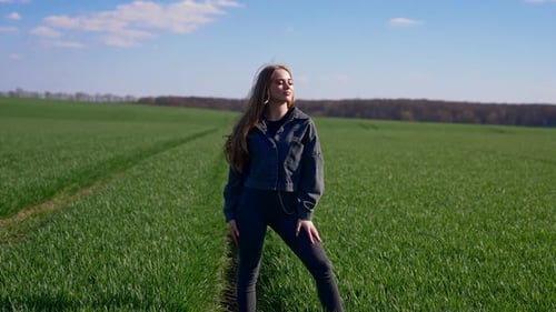 Young Woman Posing in a Green Field