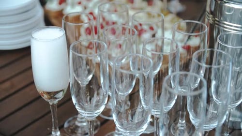 Waiter Pours Champagne Into a Glass Closeup Shooting Catering Service on the Wedding Party Event