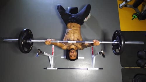 Strong Black Sportsman Doing Bench Press Workout with a Barbell at Sport Club Muscular Athlete Doing