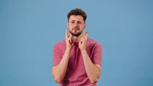 Man Asks Making Prayer Gesture and Crossing Fingers