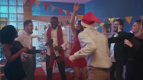 Friends dancing at holiday party in decorated home