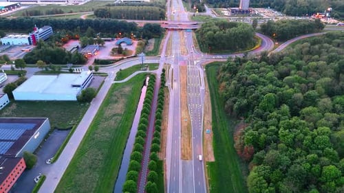 Modern highways crossing the countryside. Drone footage over the roads at sunset time.