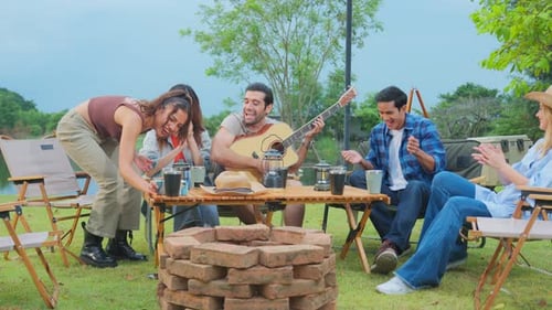 Friends Enjoying Music Together at Outdoor Gathering