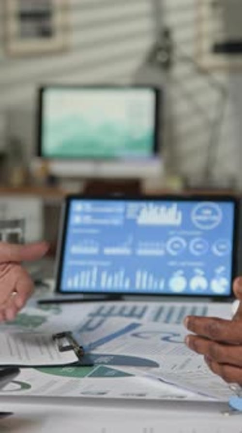Financial Professionals Discussing Data With Hand Gestures