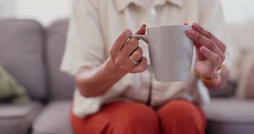 Woman Smiling and Holding Mug in Living Room